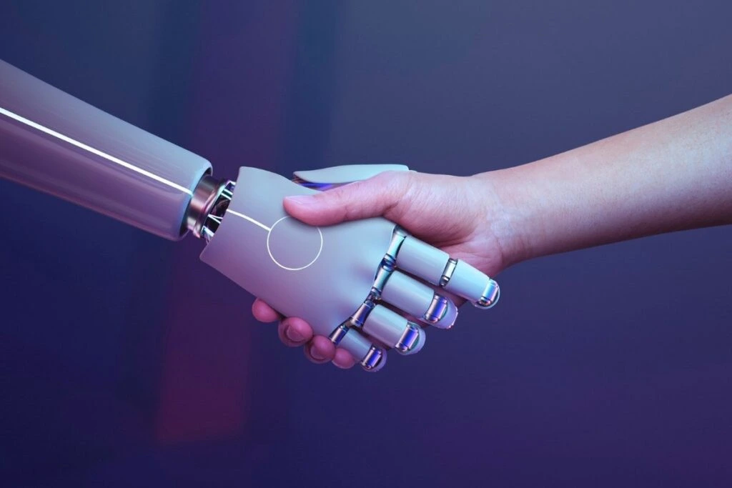 A human hand shaking hands with a robotic hand in a futuristic setting